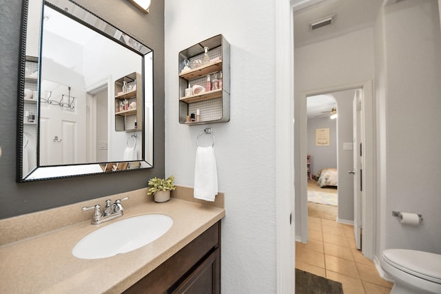19910 Standing Cypress Dr, Spring, TX 77379 - bathroom with tile patterned flooring, vanity, toilet, and ceiling fan
