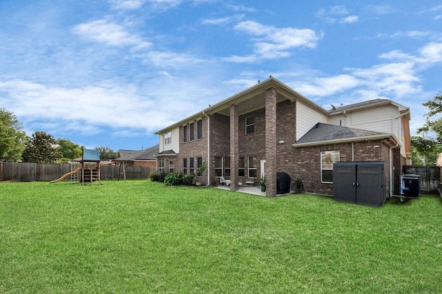 19910 Standing Cypress Dr, Spring, TX 77379 - back of house with a playground, brick siding, a patio, and cooling unit