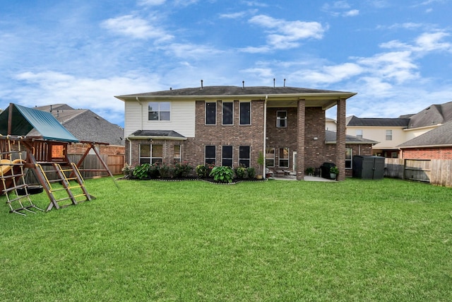 19910 Standing Cypress Dr, Spring, TX 77379 - back of house with a playground, a patio, brick siding, and a storage unit