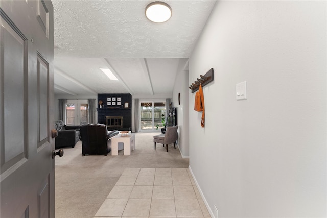 3531 Acorn Springs Ln, Spring, TX 77389 - corridor with light colored carpet, a textured ceiling, light tile patterned floors, and baseboards