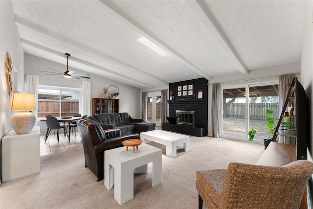 3531 Acorn Springs Ln, Spring, TX 77389 - living area featuring light carpet, a fireplace, ceiling fan, and a textured ceiling