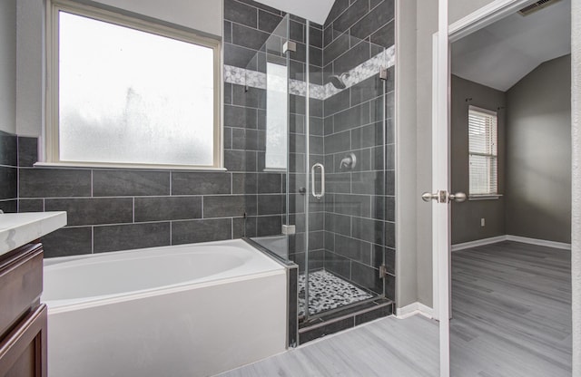 15303 Arnold, Baytown, TX 77523 - full bathroom with a garden tub, a stall shower, vanity, wood finished floors, and vaulted ceiling