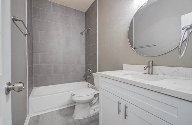 15303 Arnold, Baytown, TX 77523 - bathroom with vanity, washtub / shower combination, toilet, wood finished floors, and a textured wall