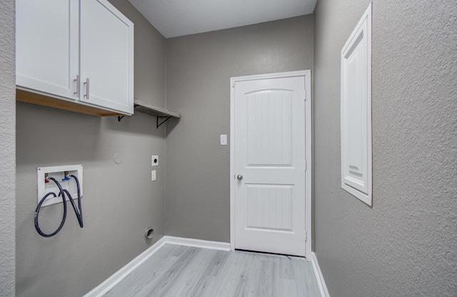 15303 Arnold, Baytown, TX 77523 - washroom with cabinet space, washer hookup, light wood-style floors, electric dryer hookup, and baseboards