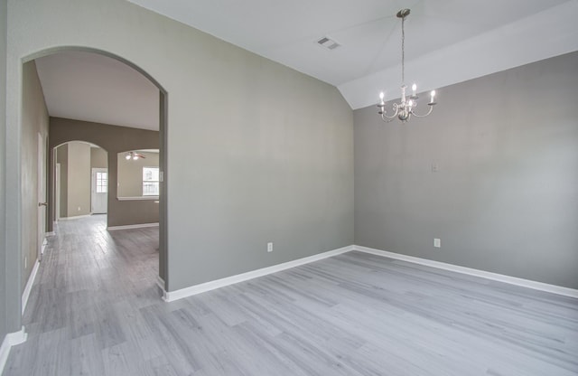 15303 Arnold, Baytown, TX 77523 - spare room featuring lofted ceiling, arched walkways, light wood-type flooring, a chandelier, and baseboards