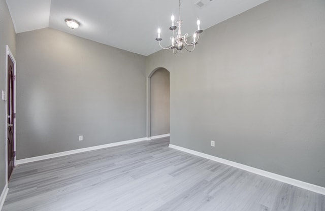 15303 Arnold, Baytown, TX 77523 - empty room featuring arched walkways, light wood-style floors, a chandelier, lofted ceiling, and baseboards