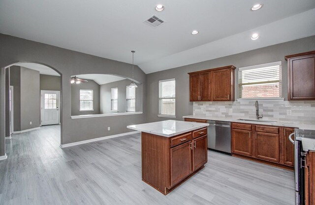 15303 Arnold, Baytown, TX 77523 - kitchen featuring stainless steel appliances, a sink, arched walkways, light wood-style flooring, and vaulted ceiling