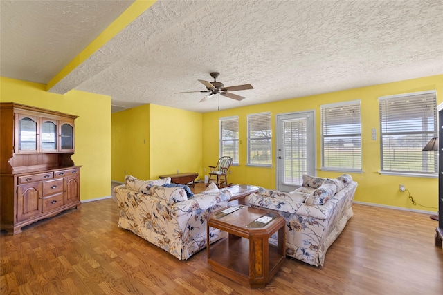 25 Willey Rd, Bedias, TX 77831 - living room featuring wood finished floors, ceiling fan, a textured ceiling, and baseboards