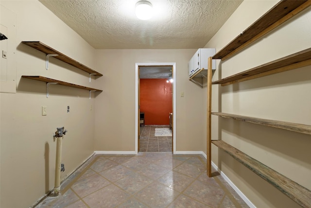 25 Willey Rd, Bedias, TX 77831 - washroom with cabinet space, a textured ceiling, light tile patterned floors, hookup for a washing machine, and baseboards