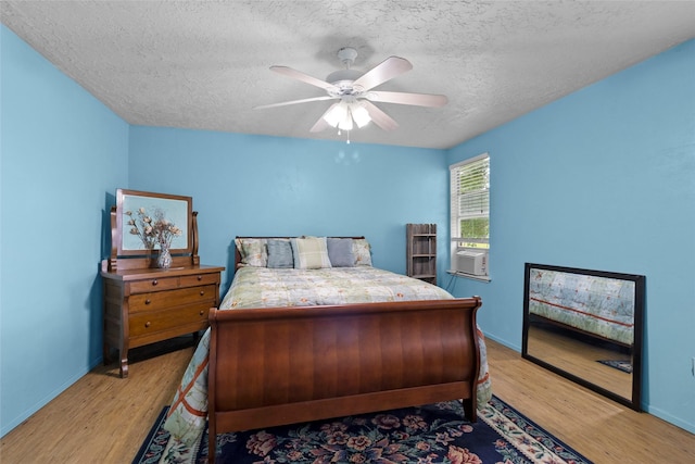 25 Willey Rd, Bedias, TX 77831 - bedroom featuring a textured ceiling, light wood-style flooring, baseboards, and ceiling fan
