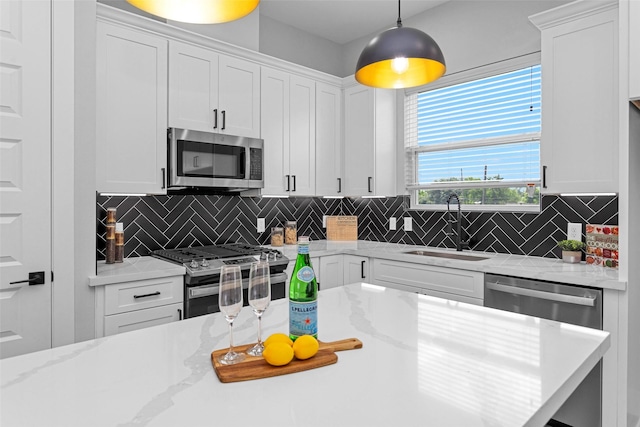 1616 Euel St, Houston, TX 77009 - kitchen featuring stainless steel appliances, a sink, white cabinets, and tasteful backsplash