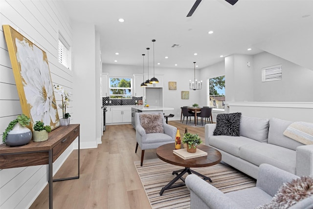 1616 Euel St, Houston, TX 77009 - living room featuring recessed lighting, light wood-style floors, a ceiling fan, baseboards, and a chandelier