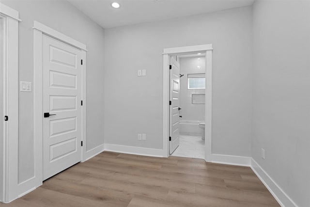 1616 Euel St, Houston, TX 77009 - unfurnished bedroom featuring wood finished floors, recessed lighting, baseboards, and ensuite bathroom