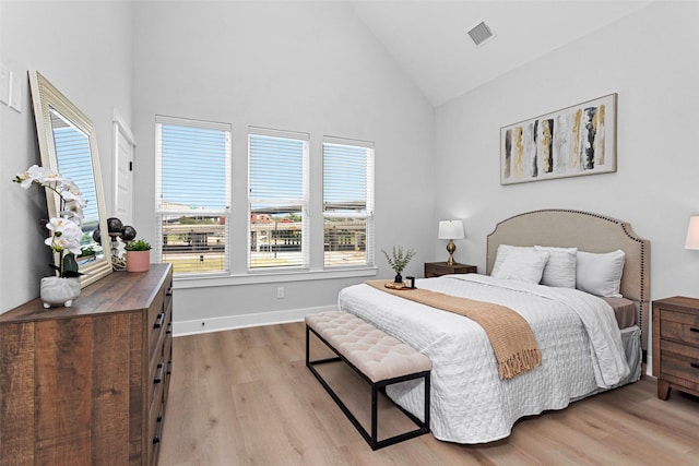 1616 Euel St, Houston, TX 77009 - bedroom featuring light wood-style flooring, high vaulted ceiling, and baseboards
