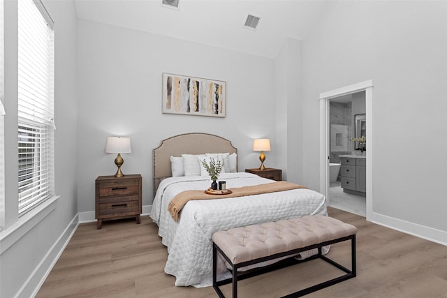 1616 Euel St, Houston, TX 77009 - bedroom featuring light wood-type flooring, baseboards, high vaulted ceiling, and ensuite bathroom