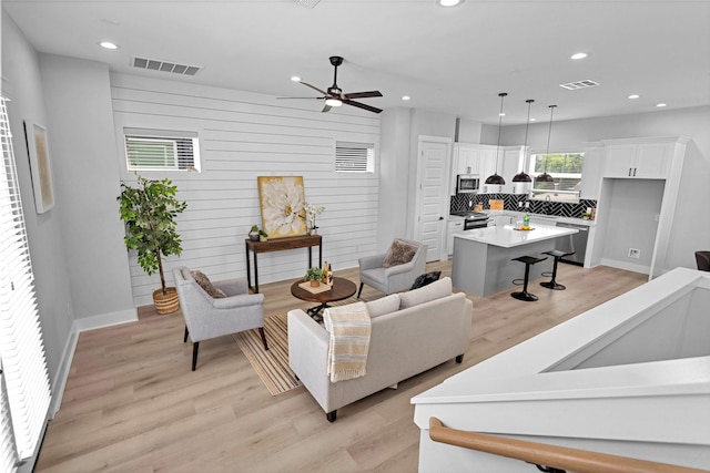 1616 Euel St, Houston, TX 77009 - living area with recessed lighting, light wood-type flooring, a ceiling fan, and baseboards