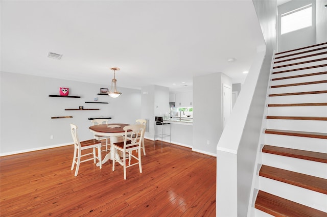 668 Lester St, Houston, TX 77007 - dining area featuring stairway, hardwood / wood-style flooring, baseboards, and recessed lighting