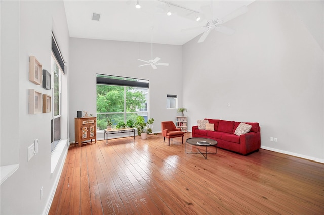 668 Lester St, Houston, TX 77007 - living room featuring track lighting, hardwood / wood-style floors, high vaulted ceiling, ceiling fan, and baseboards