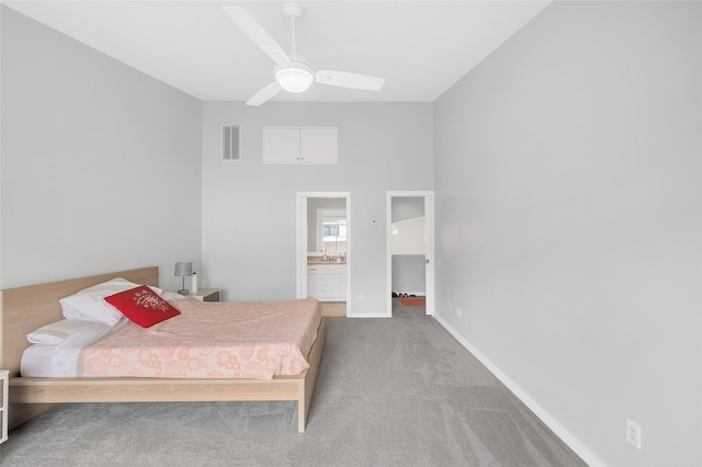 668 Lester St, Houston, TX 77007 - carpeted bedroom with baseboards, ensuite bath, ceiling fan, and a towering ceiling