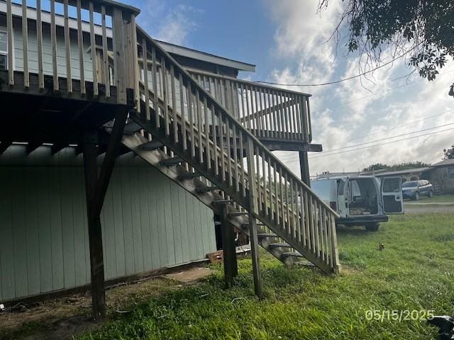 501 S 15th St, Seadrift, TX 77983 - view of property exterior featuring stairs, a deck, and a lawn