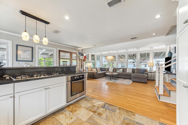 210 Queen Rd, Clear Lake Shores, TX 77565 - kitchen featuring stainless steel appliances, dark countertops, healthy amount of natural light, ornamental molding, and recessed lighting
