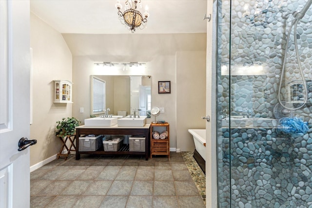 210 Queen Rd, Clear Lake Shores, TX 77565 - bathroom featuring double vanity, a freestanding tub, a shower stall, baseboards, and a chandelier