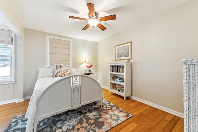 210 Queen Rd, Clear Lake Shores, TX 77565 - bedroom with wood finished floors, baseboards, and a ceiling fan