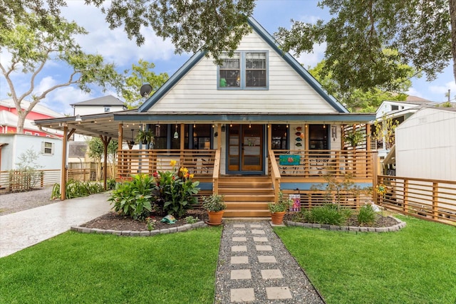 210 Queen Rd, Clear Lake Shores, TX 77565 - view of front of home with covered porch, concrete driveway, and a carport