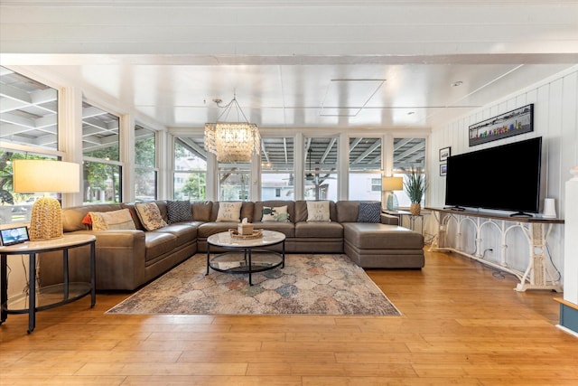 210 Queen Rd, Clear Lake Shores, TX 77565 - living room featuring hardwood / wood-style floors and a chandelier