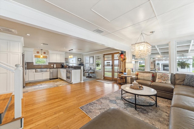 210 Queen Rd, Clear Lake Shores, TX 77565 - living room featuring light wood finished floors, a chandelier, and recessed lighting