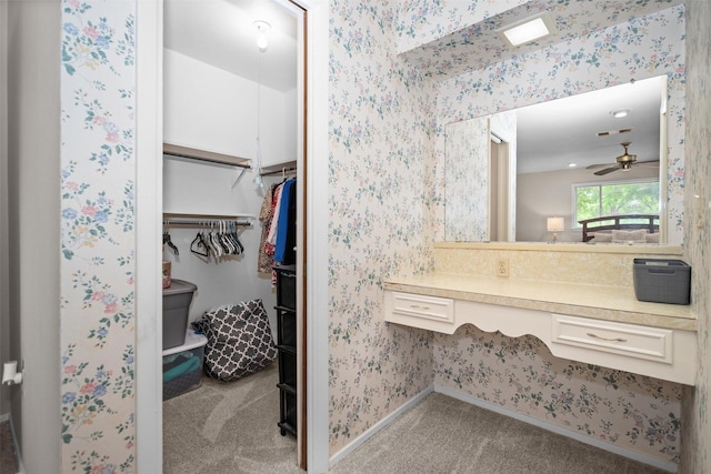 111 Ann St, Crockett, TX 75835 - bathroom with baseboards, a ceiling fan, a walk in closet, wallpapered walls, and vanity