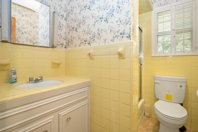 111 Ann St, Crockett, TX 75835 - bathroom with tile walls, wallpapered walls, vanity, wainscoting, and toilet