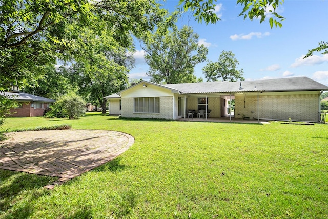 111 Ann St, Crockett, TX 75835 - rear view of house with a patio area, a yard, and brick siding