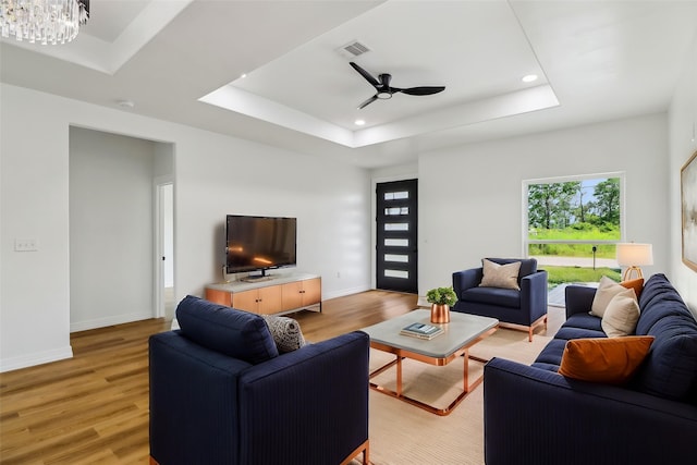 16731 Water Oak Dr, Channelview, TX 77530 - living room with a raised ceiling, light wood-style flooring, recessed lighting, baseboards, and a ceiling fan