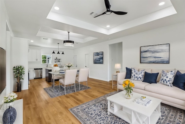 16731 Water Oak Dr, Channelview, TX 77530 - living room with a raised ceiling, ceiling fan, light wood-style floors, recessed lighting, and baseboards