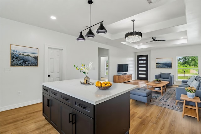 16731 Water Oak Dr, Channelview, TX 77530 - kitchen with a tray ceiling, light wood finished floors, light countertops, open floor plan, and pendant lighting