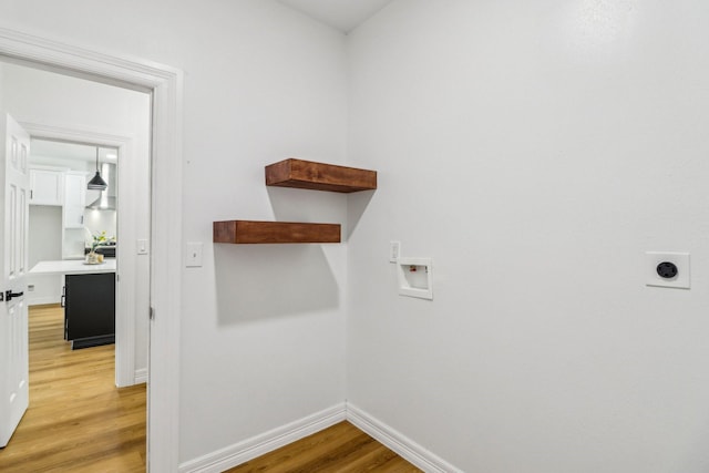 16731 Water Oak Dr, Channelview, TX 77530 - laundry room with hookup for an electric dryer, light wood finished floors, hookup for a washing machine, and baseboards