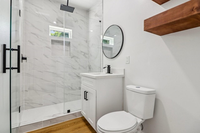 16731 Water Oak Dr, Channelview, TX 77530 - bathroom featuring a marble finish shower, vanity, toilet, and wood finished floors