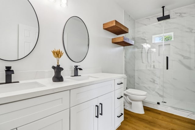 16731 Water Oak Dr, Channelview, TX 77530 - bathroom featuring double vanity, a marble finish shower, toilet, and wood finished floors