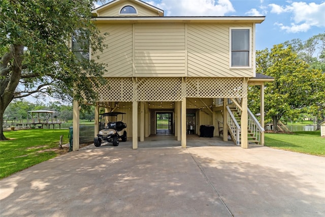 287 County Road 416, Brazoria, TX 77422 - view of front of house featuring a carport, concrete driveway, a front lawn, and stairs