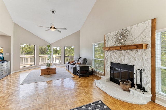 287 County Road 416, Brazoria, TX 77422 - living area with high vaulted ceiling, a ceiling fan, baseboards, and a stone fireplace