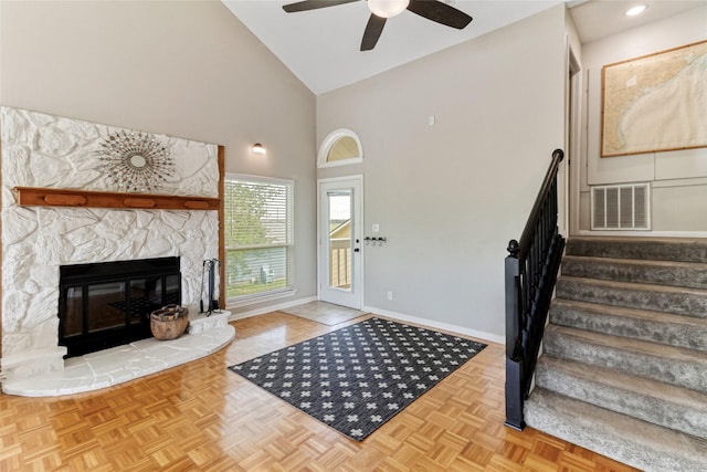 287 County Road 416, Brazoria, TX 77422 - foyer entrance with stairs, ceiling fan, high vaulted ceiling, baseboards, and a stone fireplace