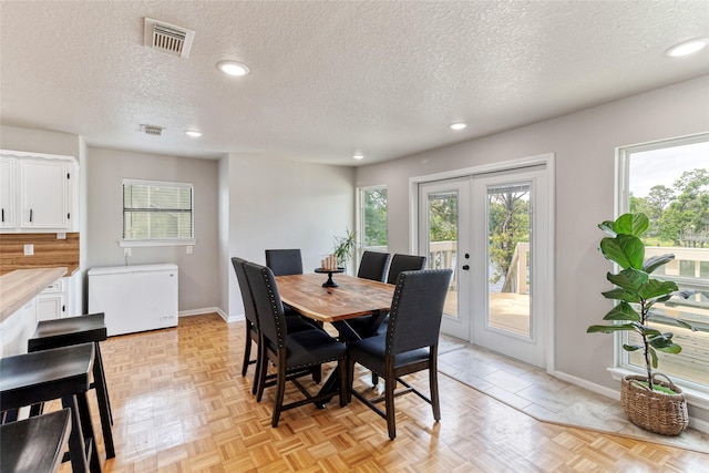 287 County Road 416, Brazoria, TX 77422 - dining room featuring a textured ceiling, french doors, baseboards, and recessed lighting