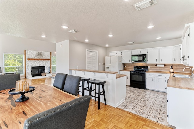 287 County Road 416, Brazoria, TX 77422 - dining room featuring a glass covered fireplace, recessed lighting, and a textured ceiling