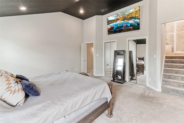 287 County Road 416, Brazoria, TX 77422 - carpeted bedroom featuring baseboards, high vaulted ceiling, ensuite bath, two closets, and recessed lighting