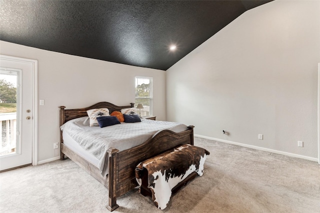 287 County Road 416, Brazoria, TX 77422 - carpeted bedroom featuring lofted ceiling, multiple windows, access to exterior, and baseboards