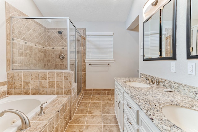 287 County Road 416, Brazoria, TX 77422 - bathroom featuring a stall shower, a tub with jets, double vanity, a textured ceiling, and tile patterned floors