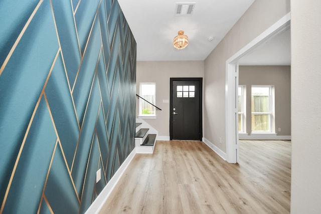 3913 Griggs Rd, Houston, TX 77021 - foyer entrance featuring stairs, light wood finished floors, and baseboards