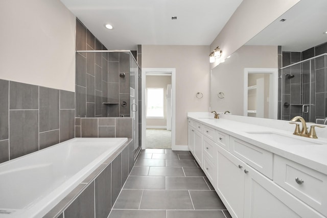3913 Griggs Rd, Houston, TX 77021 - bathroom featuring a stall shower, double vanity, a bath, tile patterned flooring, and baseboards