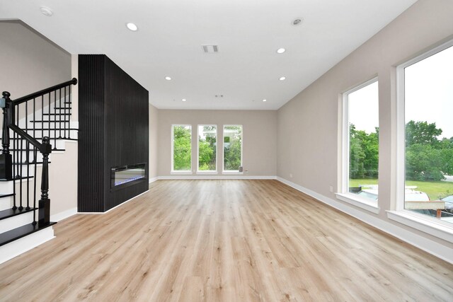 3913 Griggs Rd, Houston, TX 77021 - unfurnished living room featuring wood finished floors, baseboards, stairway, and recessed lighting